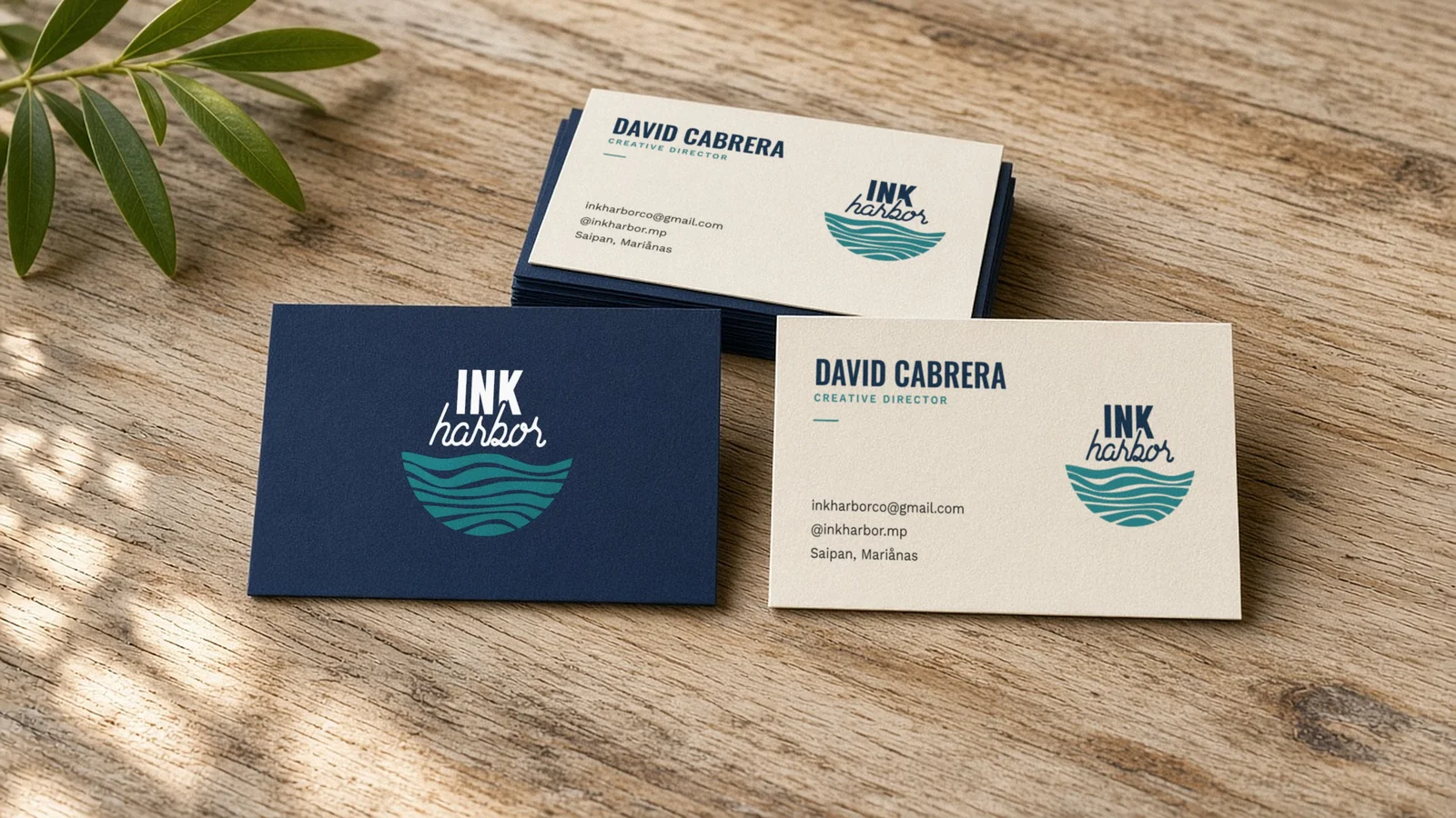 Ink Harbor business cards for Creative Director David Cabrera on a wooden table