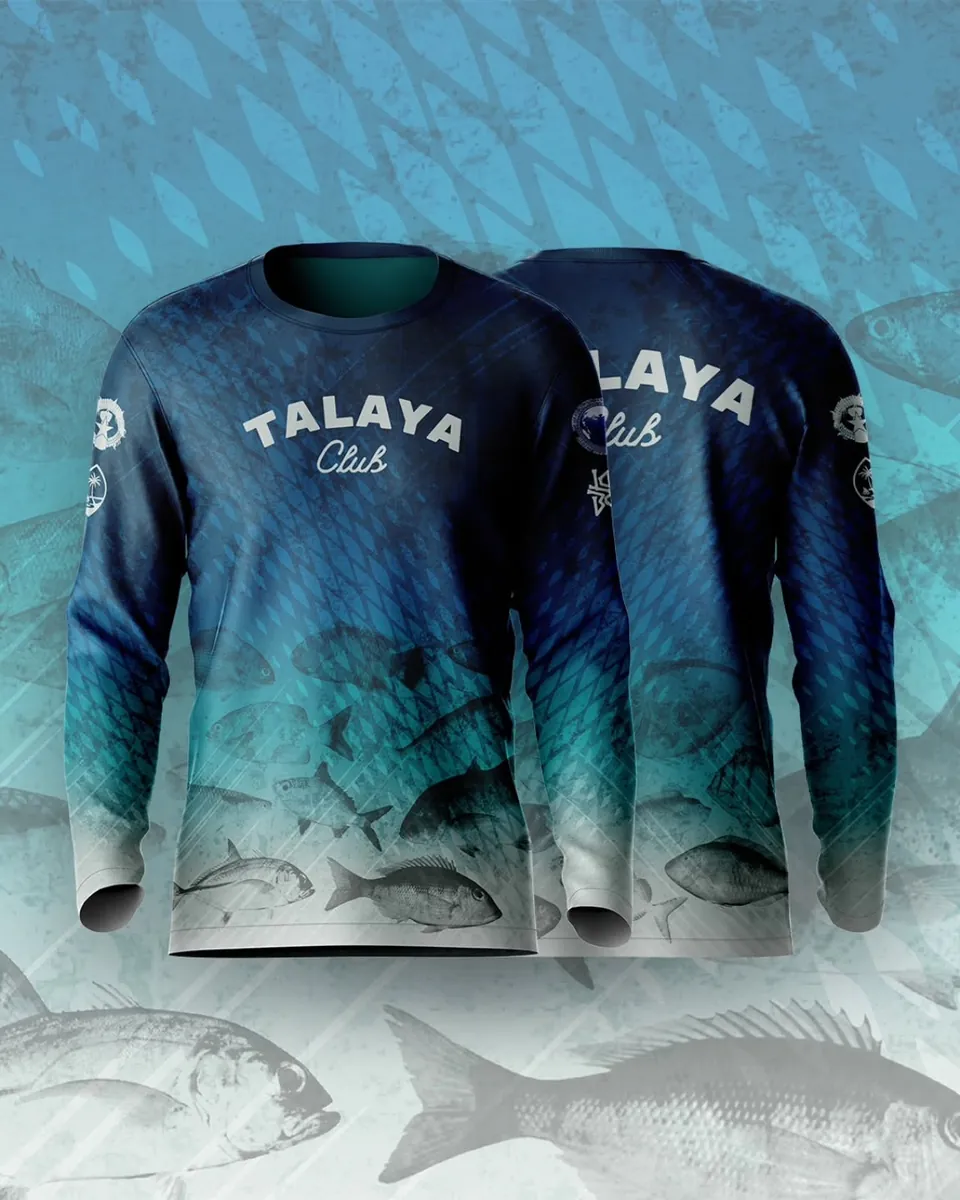 Front and back of a Talaya Club long-sleeve fishing shirt, navy fading to teal and white with engraved reef fish, over a fish-pattern background